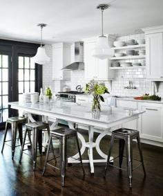 Another black and white kitchen.  The huge bar-height table instead of an island is a nice touch.