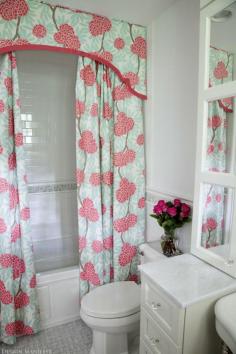 Two shower curtains with a coordinating valance. Fancy.