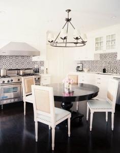 Black and white kitchen.  Sweet tile.  Love the chandelier and pedestal table, too.