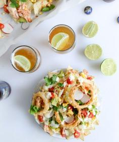 summer BBQ chicken nachos with buttermilk onion rings and white cheddar queso