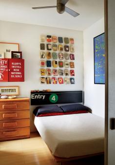 Book jackets by Alvin Lustig and a vintage subway sign hang over a custom bed by Jeff Jenkins Design + Development.  Photo by: Christopher Sturman