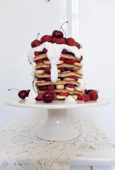 pancake cake with coconut whipped cream and fresh berries