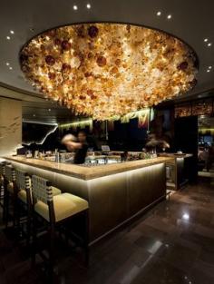 Nobu, Perth. “Our concept for Nobu was an abstracted Japanese water garden,” says the Singapore-based designer, “so these large feature chandeliers are meant to emulate the soft texture of flowing water. They are composed of hundreds of individually blown glass ‘bubbles’ all hung by hand and trimmed to create an undulating effect in the ceilings.”