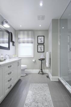 
                    
                        Gray tile floor with white vanity... Bathroom ideas/ love how they have the tiles that look like a runner carpet.
                    
                