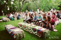 Instead of chairs, throw brightly-colored blankets and quilts over bales of hay. | 32 Totally Ingenious Ideas For An Outdoor Wedding