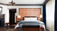 
                    
                        The High Line Hotel New York // Bedroom with patterned accent wall and antique accents.
                    
                