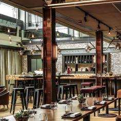 
                    
                        There are some earthy themes within a generally shiny place; the flooring is composed of outlying sections of reclaimed wood planks and baked brick in the middle, and the influence of the Mediterranean cuisine is echoed in the colour palette which uses olive green and dark timber...
                    
                