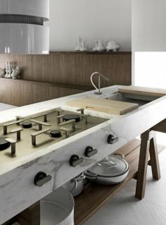 
                    
                        Enzo Berti created the handsome Dolmen kitchen with cooktops and sinks integrated into 'tables' that can be strategically placed within a space. Take your pick from an elegant materials palette that features walnut or larch wood and three types of marble. madeinlando.it
                    
                