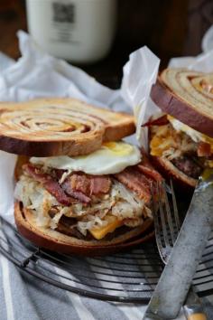 
                    
                        Cinnamon Swirl Loaded Breakfast Sandwich - www.countrycleave... Filled with bacon, sausage, hashbrowns and topped with a soft egg! You can't turn down this beast!
                    
                