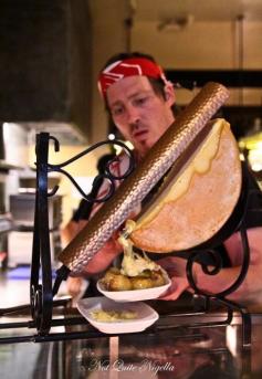 
                    
                        Bourke Street Bakery, Sydney: a copper and wrought iron raclette iron melting the half moon of raclette cheese. One of the dishes NQN reviews is La Raclette on a plate with Baby Potatoes & Pickles $ 14 plus salami $ 6 - looks lovely
                    
                