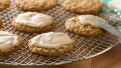 
                    
                        Dress up the classic oatmeal cookie with a touch of cardamom in the cookie and a sweet butterscotch icing on top.
                    
                