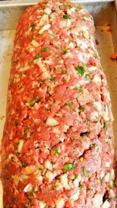 
                    
                        Uptown Meatloaf Recipe ~ this is a combination of sirloin roast & pork shoulder freshly ground with dried fennel seeds. And added fresh herbs, eggs, soft ciabatta crumbs, garlic and onion. Spread it out on a baking sheet, covered it with plump sun-dried tomatoes, fresh basil & thick slices of creamy mozzarella then rolled it up. After roasting serve whole slices on pools of garlicky tomato sauce
                    
                