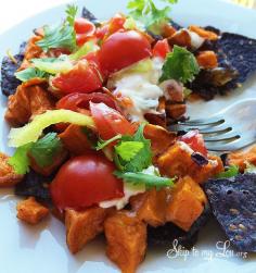
                    
                        Sweet Potato Nachos Recipe. Simply roast cubed potatoes, serve over chips, and top with your favorites #recipe #nachos #potato skiptomylou.org
                    
                