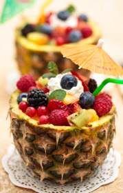 Too cute! Recipe for  Luau Hawaiian Fruit Salad - For your next garhering use real fruit as centerpieces using the whole pineapple as your fruit bowl.