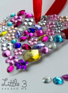 
                    
                        Jeweled Heart Suncatcher. How cute would this be hanging in a little girls room or on her door. AND she can make it herself! Glue plastic jewels onto heart-shaped tagboard!
                    
                