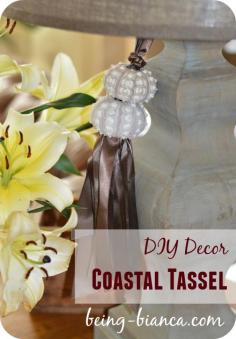 
                    
                        Easy DIY home decor with a coastal vibe - this easy to make ribbon tassel uses beautiful sea shells (sea urchin shells) to make a great statement on a tiny budget.  Easy craft DIY for the home.
                    
                