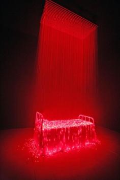 
                    
                        Bright Red Lights Illuminate a Bed Covered in Eerie Mist
                    
                