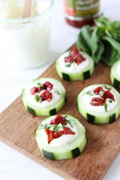 Cucumber Canapés with Whipped Feta, Sun-Dried Tomatoes and Basil on twopeasandtheirpo... An easy appetizer for the holidays! #appetizer