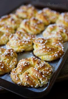 Swedish Orange Sweet Buns made with a buttery, cardamom dough layered with fragrant orange sugar, then knotted, topped with Swedish pearl sugar and baked until they're golden brown.