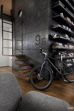 
                    
                        The largest custom creation in the small space is the large black box that stands at the center of the room. Though you would never guess it, this room is perched atop the building's elevator shaft and actually contains the apartment's bathroom. The exterior material is dark concrete paneling which looks worn as though it has always been a part of this building.
                    
                