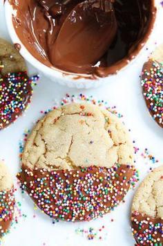 Chocolate Dipped Peanut Butter Cookies with Sprinkles! We could dye white chocolate mint and coral colored!