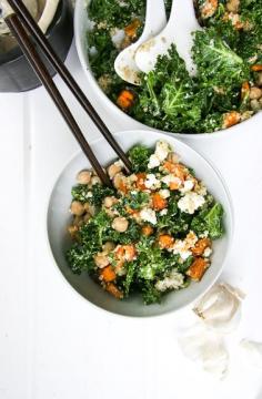 Kale and quinoa salad bowls with chickpeas, roasted sweet potatoes, and tahini dressing
