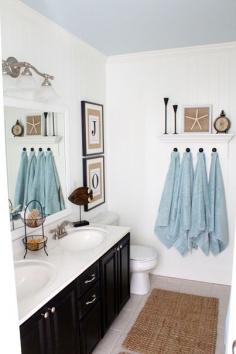 DIY Coastal bathroom Love the white walls, blue ceiling, black vanity & towel hooks!