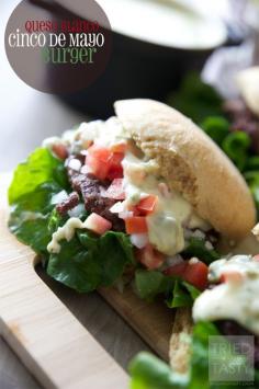 Queso Blanco Cinco De Mayo Burger // What better way to celebrate than with this ooey, gooey, cheesy burger? All of your favorite Mexican flavors piled high on a juicy burger make this one not to be missed! Have this for Cinco De Mayo AND all summer long! | Tried and Tasty
