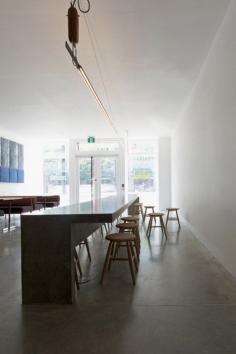 
                    
                        Torafuku restaurant features large communal concrete table
                    
                