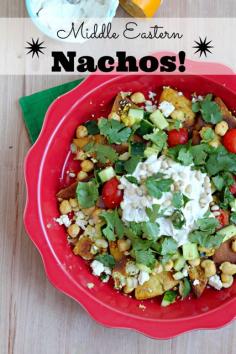 Middle Eastern Nachos made with pita chips, Greek yogurt, chickpeas, Israeli cucumber tomato salad and more! Healthy and homemade.  -- I'll have to try, but make it GF with tortillas --