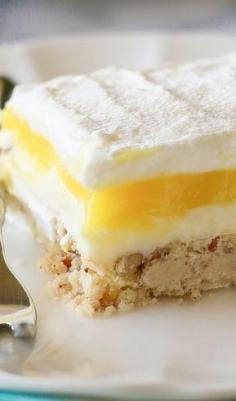 Lemon Lush - buttery pecan crust with a lemon cheesecake filling, lemon pudding layer, and whipped cream. [ KellysDelight.com ] #dessert #delight #sugar