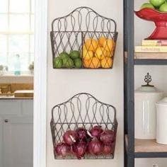 Hang magazine racks as holders for  fruit and veggies. Such a good idea to help the lack of space situation in our kitchen.