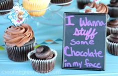 Frozen birthday party food idea - chocolate cupcakes with "I wanna stuff some chocolate in my face" sign