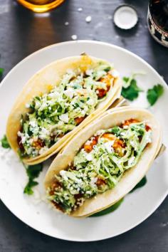 BEST recipe EVER...except the cheese. Spicy Shrimp Tacos with Garlic Cilantro Lime Slaw - ready in 30 minutes and loaded with avocado, spicy shrimp, and a homemade creamy lime slaw.  Best tacos I've ever had!