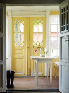 I used to live in a garage apartment that I called "the dollhouse." It had the narrowest French doors for entry, a tiny upstairs loft, half-sized refrigerator, and a pantry that was one soup can deep. I love these yellow doors, which remind me of those in the house I used to live in.