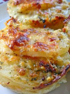 Parmesan Potato au Gratin - Baked in a muffin tin! (combine 2 minced garlic cloves, 2Tbsp minced onion or shallot, 2c half-n-half, 1/2c grated parmesan, 1/2tsp each s+p, 1Tbsp chopped fresh thyme. Thinly slice 2-3med. russet potatoes. Stack tightly 7-8slices in each of 6 greased muffin cups (no higher than the cup rim). Pour cream mix over taters; sprinkle with another 1/2c parmesan. Bake @ 400deg 45-50min til all liquid absorbed. Note: put pan under muffin tin to catch drips.)