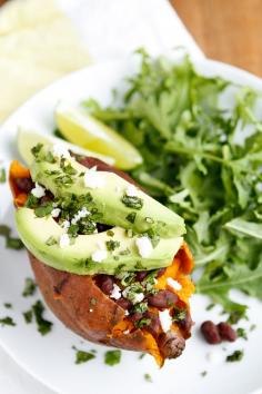 Baked Sweet Potato -- these loaded baked sweet potatoes, topped with honey-lime chipotle black beans, sliced avocado, crumbled queso fresco, and chopped fresh cilantro, are a  fantastic meatless meal solution! One of our fave Lent recipes...
