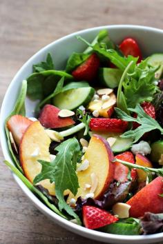 Try this fruity Strawberry Peach Salad for a fresh, fast, and healthy meal any time of day! Fresh greens topped with juicy nectarines, ripe strawberries, cucumber, goat cheese, sliced almonds, and a yummy honey balsamic dressing. | LoveGrowsWild.com