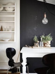 
                    
                        Black chalk wall in the dining area of a calm Swedish space high up in the rooftop. Stadshem. My Scandianvian Home.
                    
                