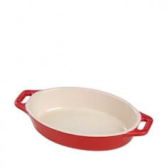 Ramekins & Ceramic Bakeware - Standing tough against thermal changes and impact, the 9" Staub Oval Dish is beautifully crafted of 100% ecological ceramic with a porcelain glazed finish. PTFE- and PFOA-free, the Staub baking dish evenly distributes and holds heat for your meats, vegetables, pasta dishes and desserts. Ceramic baking dish is microwave- and oven-safe to 572 F, broiler-safe and freezer-safe. Secure-grip loop ergonomic handles make carrying easy for beautiful oven-to-table presentation. Dishwasher safe, but hand washing recommended.A benchmark for artisan quality and durability, Staub is the preferred bakeware of choice, used in restaurants around the world. Product Features Crafted of 100% ecological ceramic and porcelain glazed finish Thermal shock and impact-resistant Tolerates temperature fluctuations from freezer to oven or microwave to table Fine polished base will not scratch surfaces Secure-grip loop ergonomic handles make carrying easy PTFE- and PFOA-free Microwave- and oven-safe to - Specifications Material: ceramic, porcelain glazed finish Model: 40511-156 (cherry), 40511-157 (dark blue), 40511-158 (white) Capacity: 1 qt. / .95 L Size: 9"L (11" with handles) x 6"W x 2"H Weight: 2 lb. Made in China Use and Care Microwave- and oven-safe to 572 F and broiler-safe. Freezer-safe. Dishwasher-safe, but hand washing recommended.