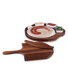 Picnic Time has created another original gift idea for those who enjoy making and baking their pizzas at home. The Pizza Prep Station consists of an acacia base on which a 13 ceramic pizza stone sits. Three ceramic dishes, which can be filled with various sauces and pizza toppings, sit conveniently atop the base. Place your pizza dough on the stone, garnish it, then transfer the pizza stone to your pre-heated oven to bake. When the pizza is done, use the acacia pizza peel to remove the pizza from the stone in the oven, let the pizza cool, then use the acacia pizza cutter, located in the side of the base, to slice up your masterpiece.