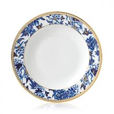 Bring stylish elegance to the breakfast table with this Hibiscus soup plate from Wedgwood. Inspired by a Wedgwood archive pattern dating back to 1810, the crisp white bone china is adorned with a striking botanical pattern in oriental blue hues. Beautifully hand-lined in gold for an opulent finish, this soup plate is a welcome addition to any dinner party and looks fabulous paired with more pieces from the Hibiscus collection. Please note: Wedgwood bone china items require specialist care, we recommend that our care guide is read & all care instructions on packaging are checked before washing each item for the first time. The Wedgwood & Vera Wang for Wedgwood care guide can be found here, along with a full list of approved washing detergents. Key features: * Material: fine bone china, gold * Dimensions: H2.5xW23xD23cm * Elegant soup plate with a lavish botanical pattern * Hand-lined in gold for an opulent finish * Inspired by a Wedgwood archive pattern dating back to 1810 * Dishwasher safe * More charming tableware available from Wedgwood