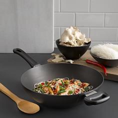 Scanpan is the first producer of nonstick cookware certified PFOA free, so ita s safe for your family and the environment. This professional-quality wok is great for stir-frying, steaming, deep-frying, sautA ing, braising, and more. Little to no added fat is required for cooking, so you can enjoy a healthy meal with minimal cleanup. Heavy-duty pressure-cast aluminum body features a thick base, ensuring fast and even heat distribution. Patented ceramic titanium nonstick cooking surface is impossible to scrape away, even with metal utensils. Wok is guaranteed not to blister, peel, or create hot spots. Sturdy, ergonomic handle stays cool during stovetop cooking. Dishwasher safe, but hand washing recommended. Oven safe to 500A&deg;F. Lifetime warranty. Made in Denmark.