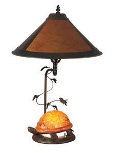 Metal base in antique bronze paint Table lamp in Tiffany style Empire shaped lamp in mica shade Requires (1) 60-watt E27 and (1) 15-watt E12 bulbs (not included) Dimensions: 14.75L x 14.75W x 22.75H inches An orange-shelled turtle pauses under the amber mica shade on the Dale Tiffany Mica Amber Orange Turtle Table Lamp, creating a blend of fun and elegance for this beautiful light. This table lamp has a metal base in antique bronze, and uses one 60-watt bulb for the main fixture and one 15-watt bulb for the turtle's shell (bulbs not included). About Dale Tiffany Founded in 1979, Dale Tiffany, Inc. started manufacturing Tiffany-styled lamps and shades, emphasizing high-quality reproductions of Louis Comfort Tiffany's famous designs. Today, using only the highest quality genuine hand-rolled art glass, Dale Tiffany offers an extensive range of designs to comprise the world's foremost collection of fine art glass lighting and home accents. With this hand-crafted process, no two pieces are exactly alike, making each design a treasured keepsake. Dale Tiffany captures the timelessness of America's classic designers while developing unique designs that blend perfectly with today's home fashion trends and lifestyles.