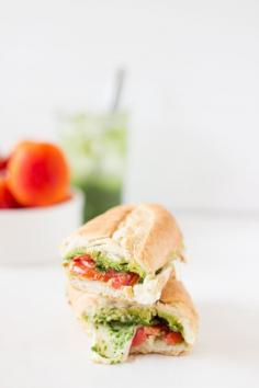 This Caprese Sandwich takes a twist by being toasted with melted mozzarella, and creamy parsley pesto. The sandwich is perfect for an everyday lunch or a picnic! #vegetarian