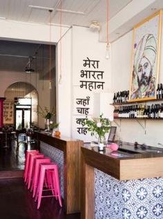 Indian restaurant in Melbourne Australia Hot pink Tolix stools stand out against the bar's blue and white tiles
