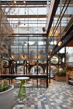 The Prahran Hotel, Melbourne, Australia. The natural materials and soft upholstery take the edge of the concrete, steel and glass used in the interior. The banisters are covered in leather for a luxe, surprise element.