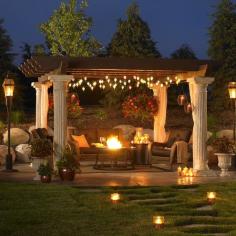 A very nice outdoor patio setup with a huge pergola by Outdoor Greatroom Company