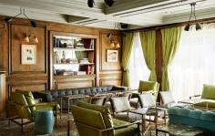 
                    
                        The Marlton Hotel New York // Wooden seating area with traditional furniture and green accents.
                    
                