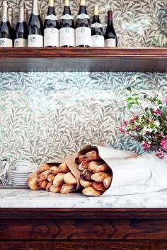 
                    
                        Petit Trois Los Angeles restaurant tour // Fresh baguettes and floral wall.
                    
                